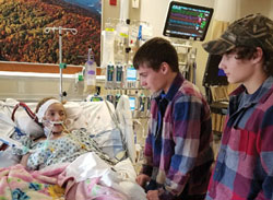 Brothers Hunter and David Jessie visit their sister Breanna in the hospital.