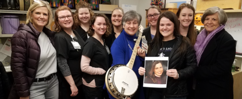 Members of the Creative Arts Program with the banjo donated by Daphne's Legacy, Inc.