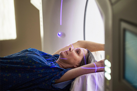 A female patient undergoes a scan.