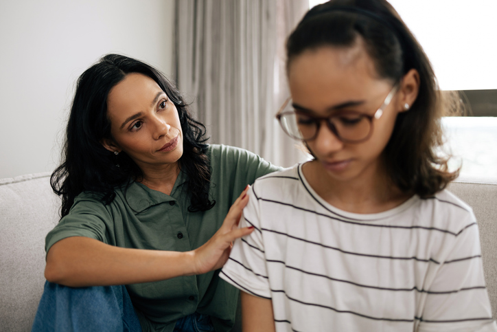 A mother consoles her daughter.