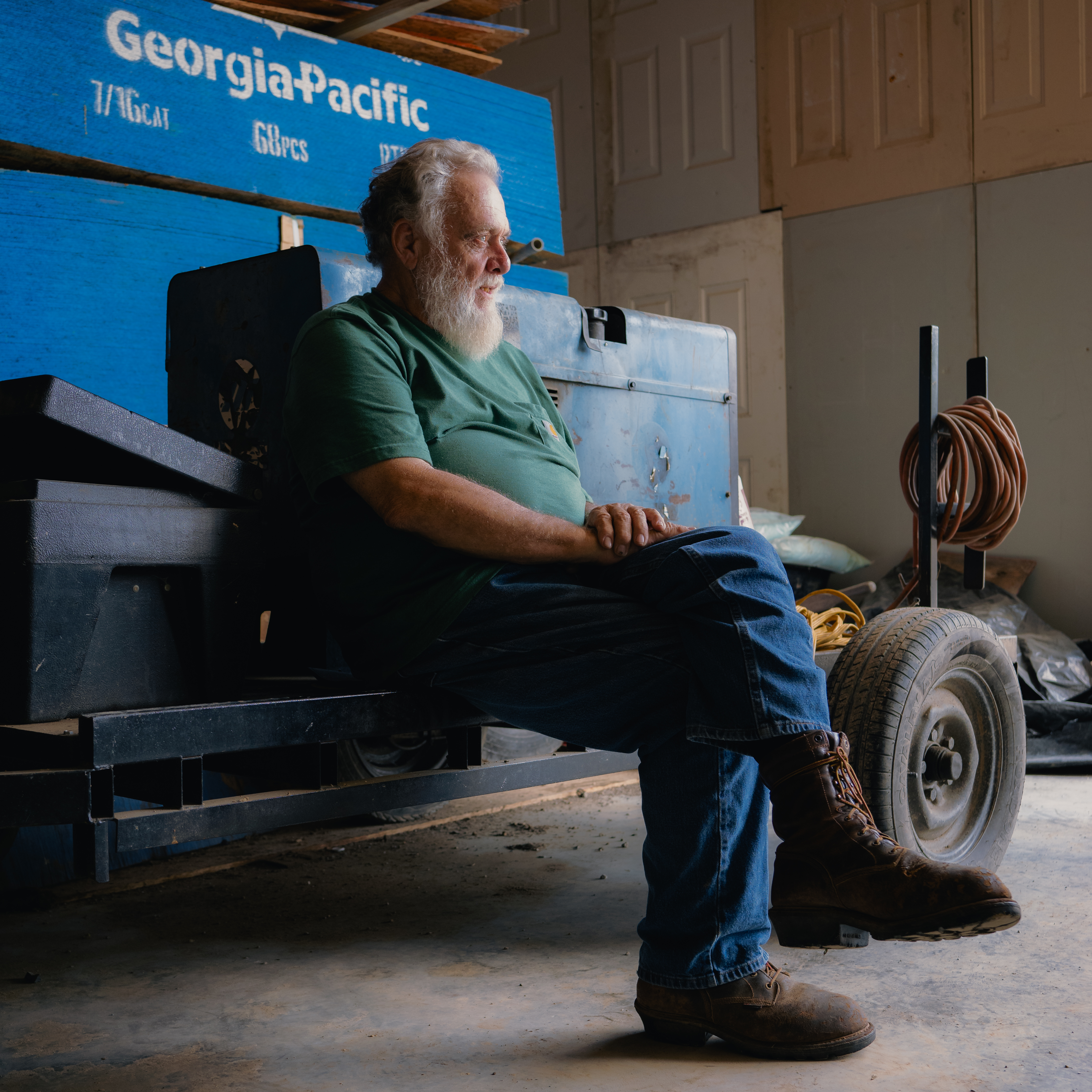 Shorty Carson sitting on equipment in his garage