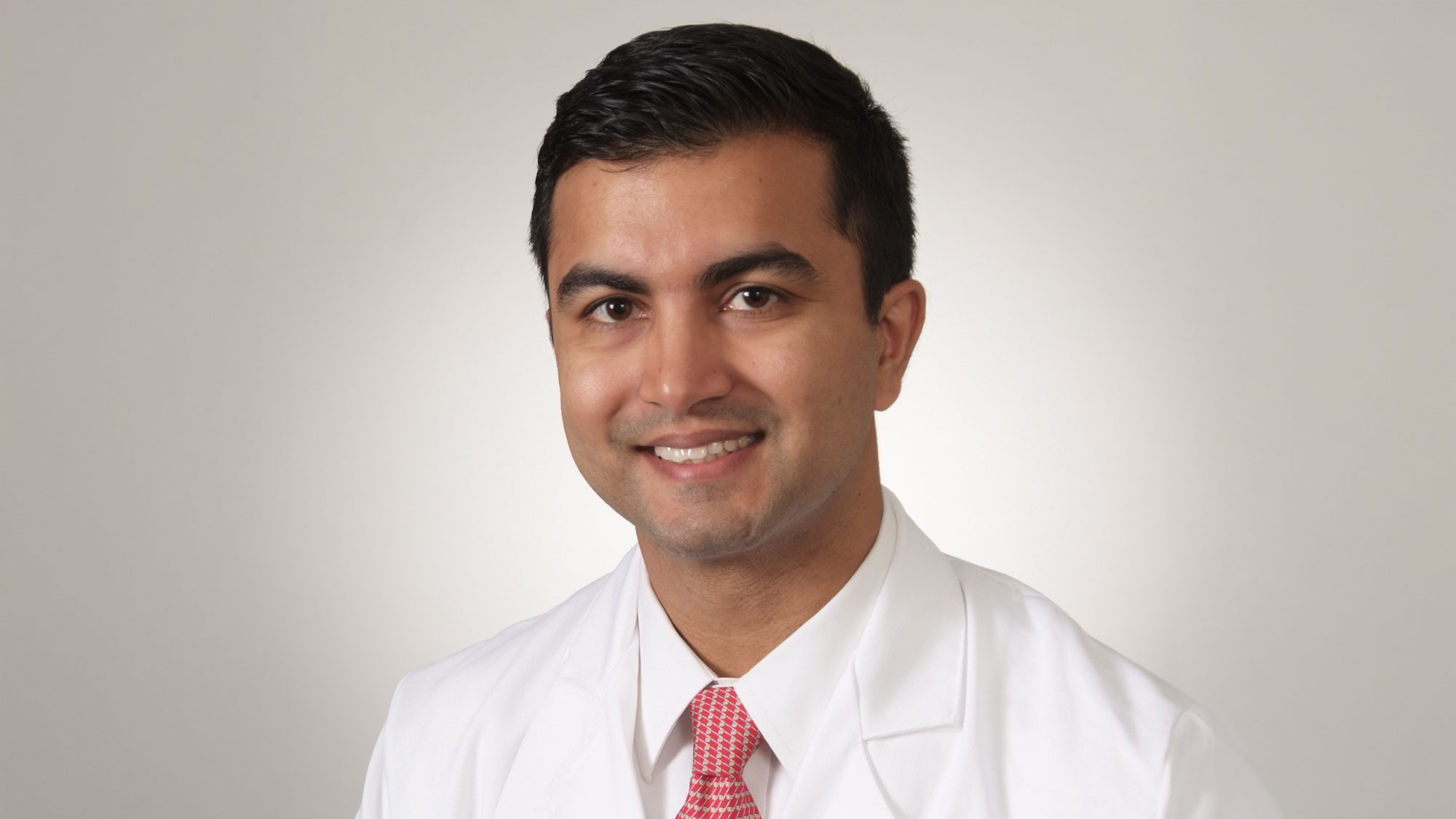Dr. Samuel Tyagi smiling at a camera