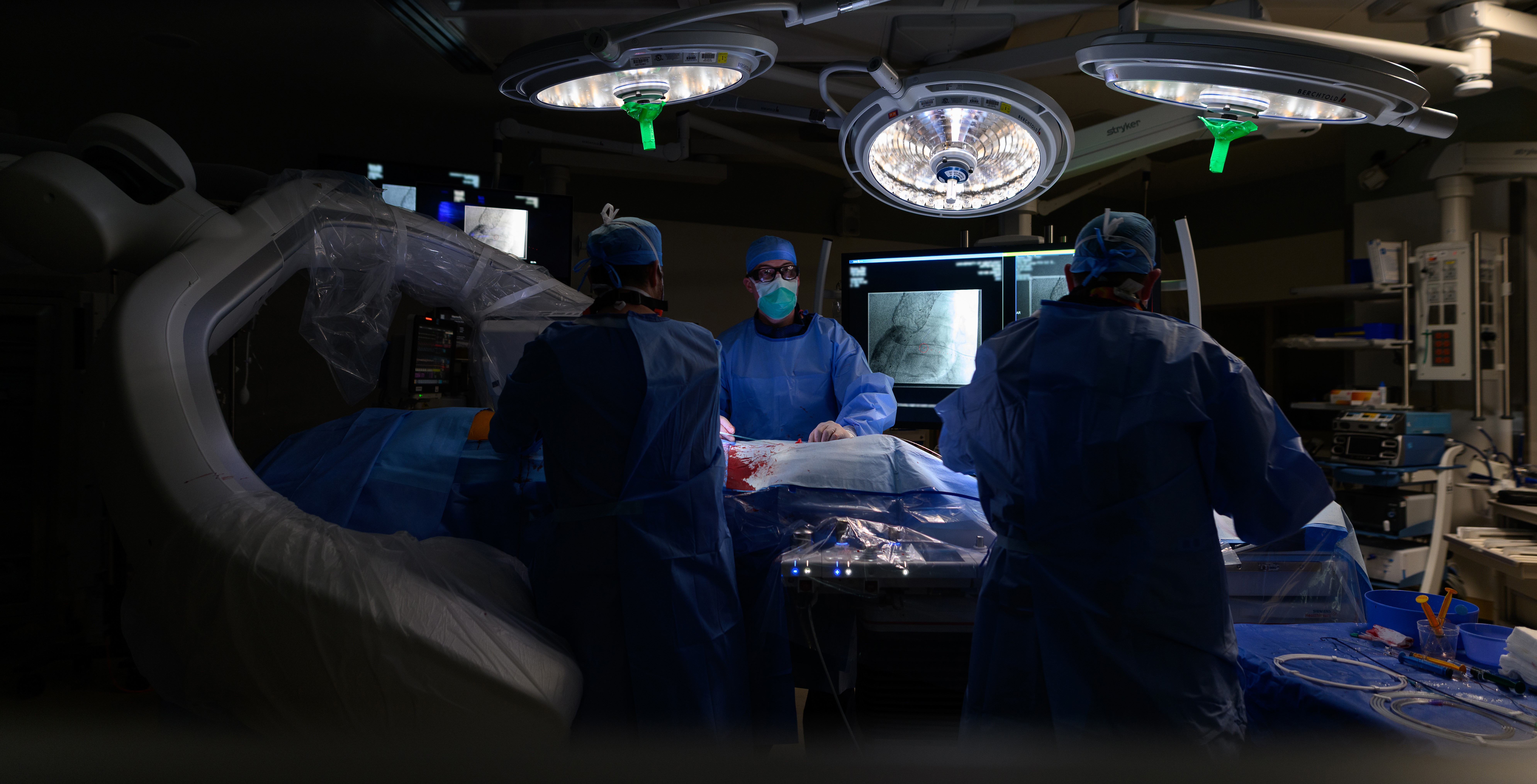 Cardiology specialists treat a patient in the operating room.