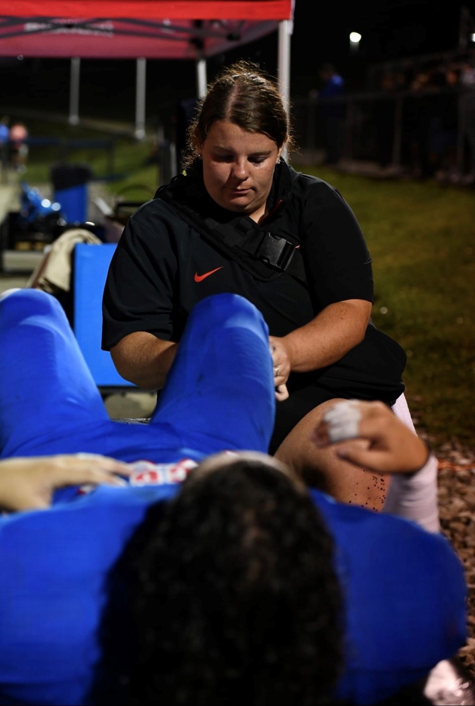 Athletic Trainer Brittany Martin tends to an athlete.