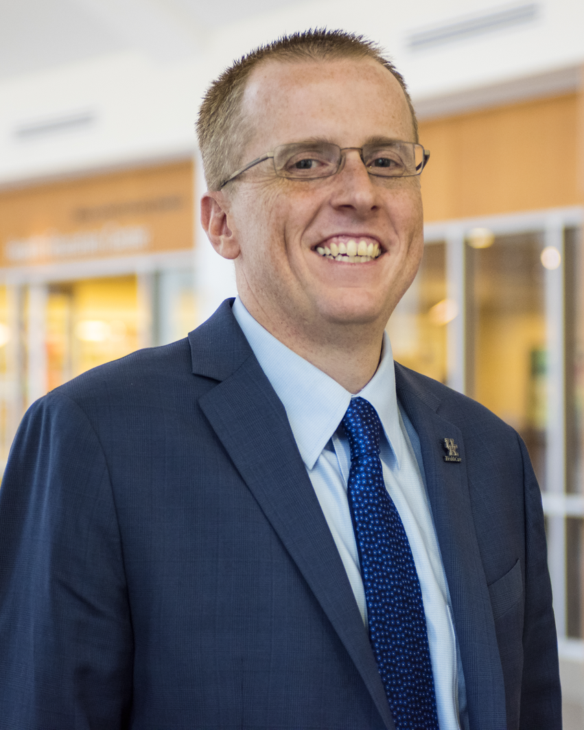 Portrait of Dr. Scottie Day against a windowed background