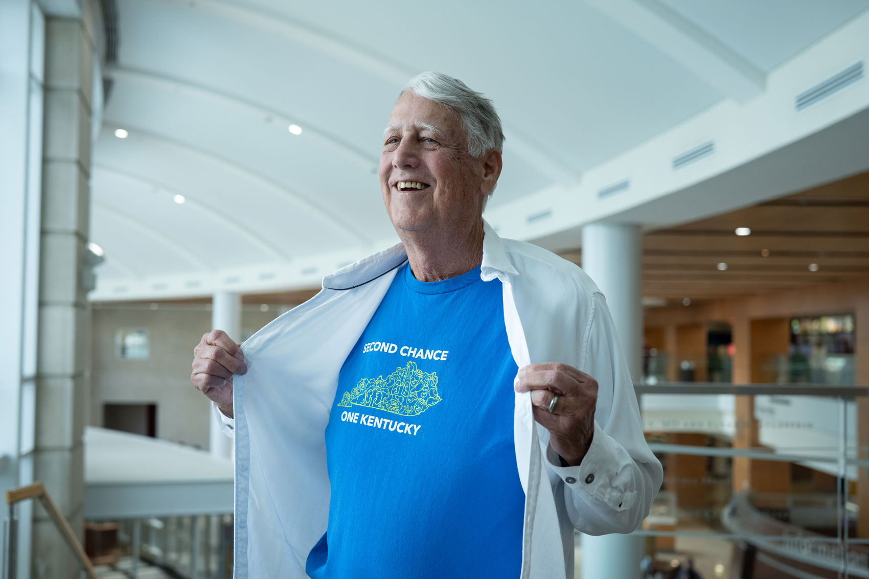 Tom Williams poses for a photo where he reveals a T-shirt that says Second Chance One Kentucky under a white collared shirt