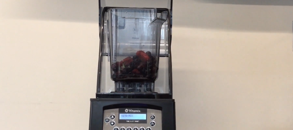 Ingredients for a mixed berry smoothie in a blender.