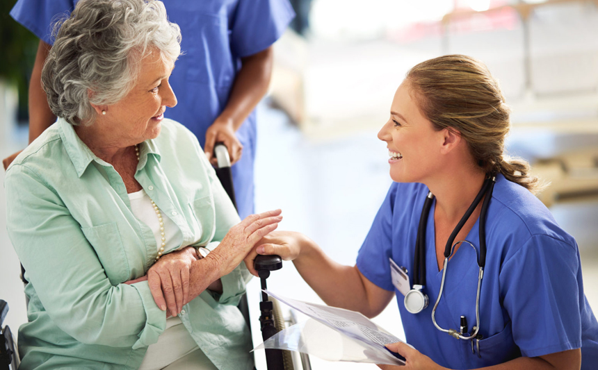 A care provider talks with a patient.