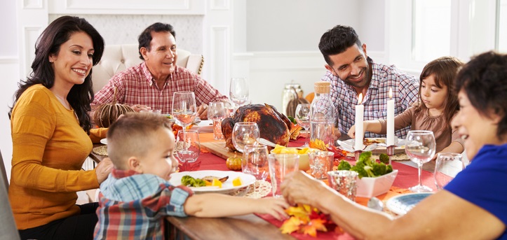 Family eats Thanksgiving dinner.