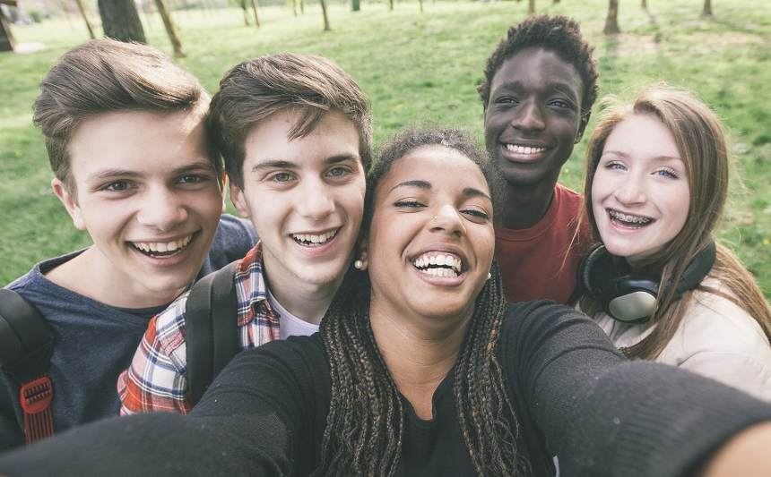 A group of adolescents take a selfie.