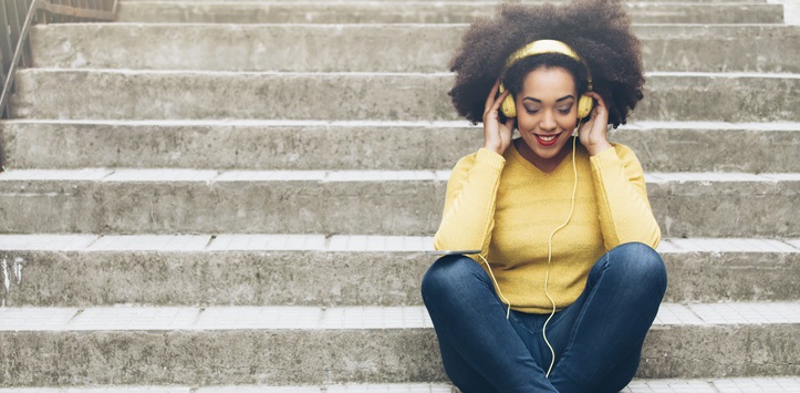 Woman listens to music using headphones.
