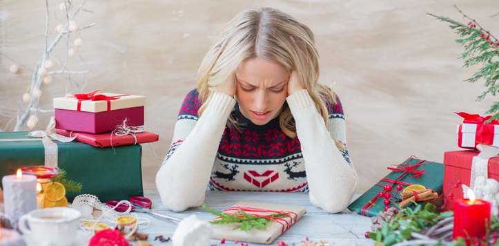 Exhausted and overwhelmed woman packing Christmas gifts