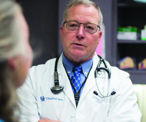 Thoracic surgeon Timothy Mullett, MD, talks with lung cancer patient Vickie Duff.
