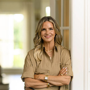 Lee Anne Pope stands in the doorway of her home.