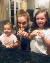 Morgan Chojnacki eats cookies with her daughters.