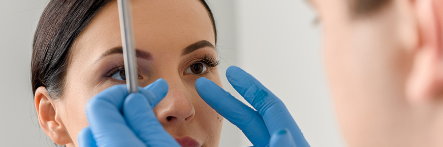 Clinician examining woman's face