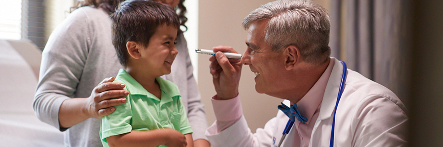 Doctor examining a little boy