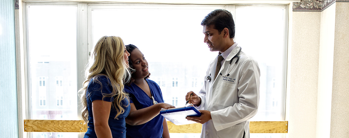 Doctor discussing treatment plan with nurses.