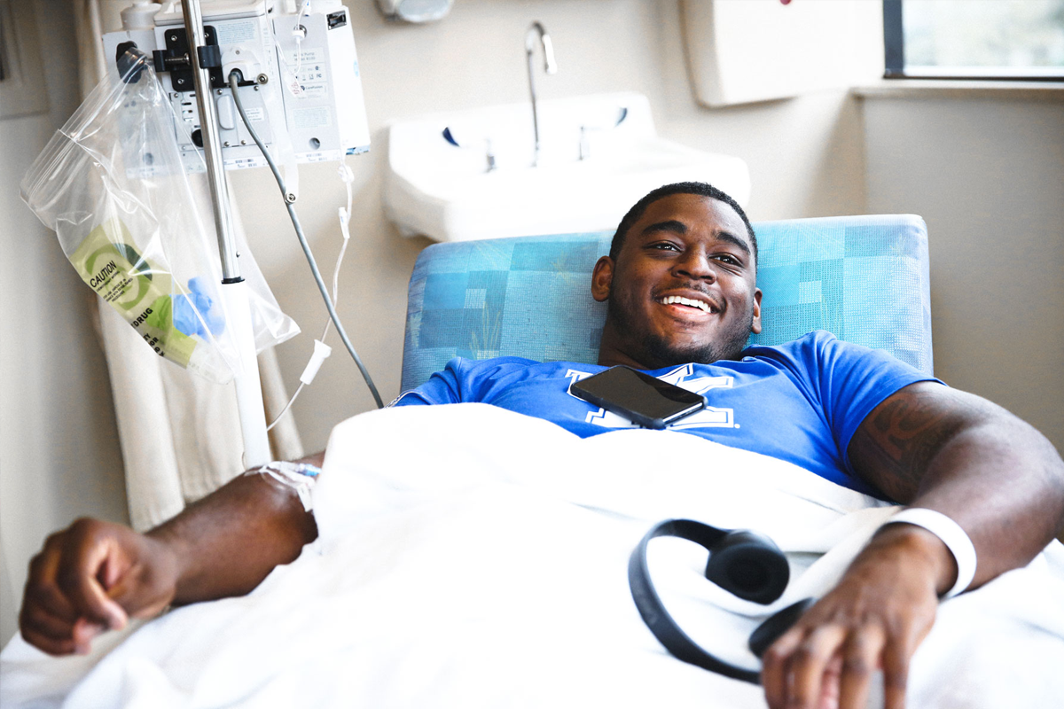 Josh Paschal smiles from his hospital bed.