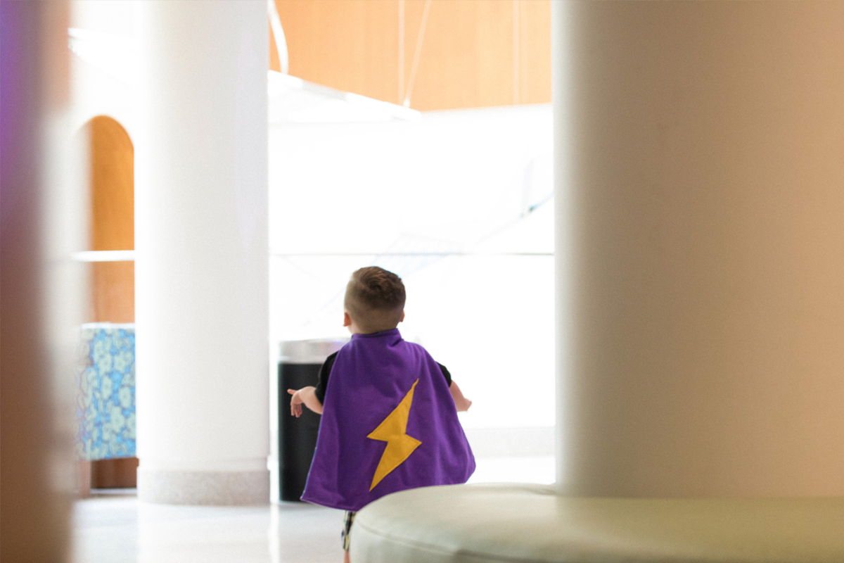 Kase Chaney wears a purple superhero cape.