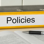 A binder labeled "policies."