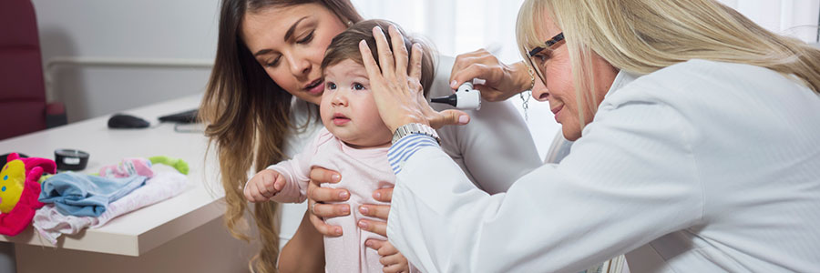 Doctor examining a toddler's ears