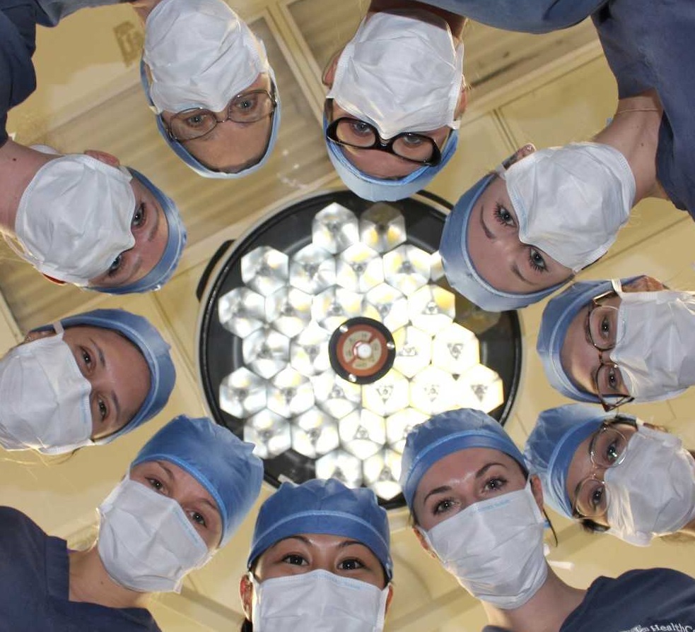 Ten urologists peer over the operating table.