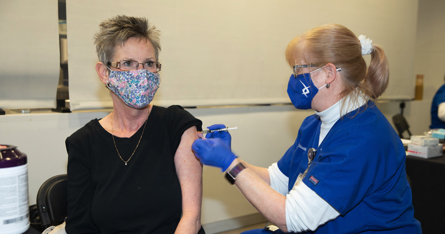 Nurse administering the COVID-19 vaccine.