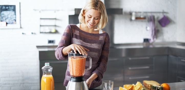 Woman makes a smoothie.