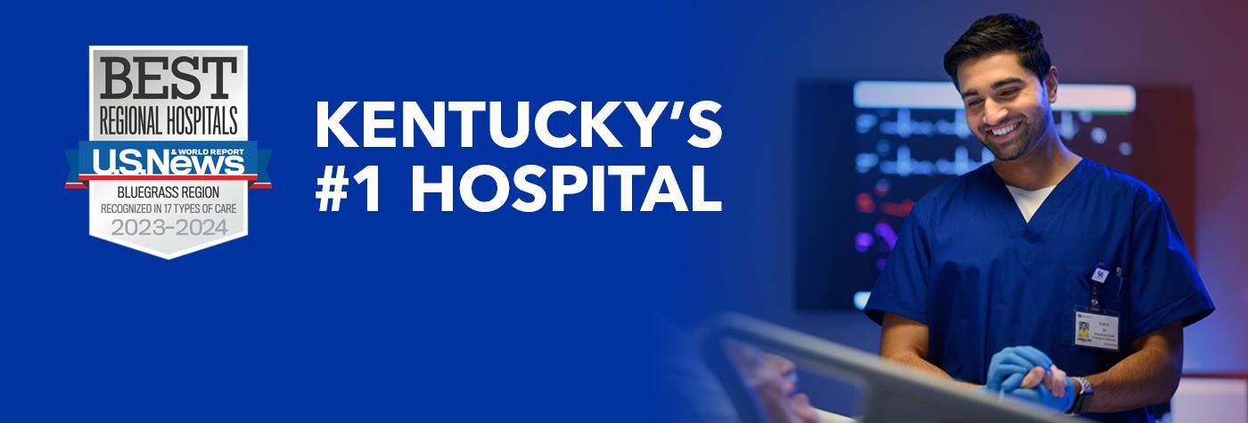 A smiling male provider wearing blue scrubs holds the hand of his patient, an older man in a hospital bed who is smiling and speaking. A headline on the image reads "Eight years as Kentucky's #1 hospital." Superimposed on the image is a badge that reads "US News & World Report Best Regional Hospitals, Bluegrass Region, Recognized in 17 Types of Care, 2023–2024."