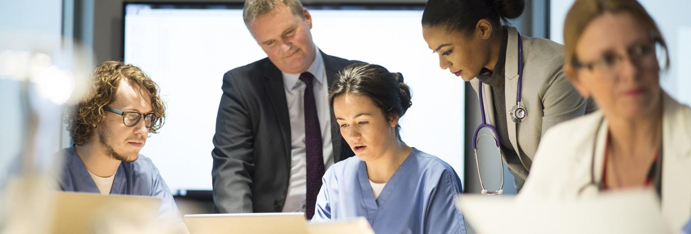 Group of medical professionals reviewing case information.