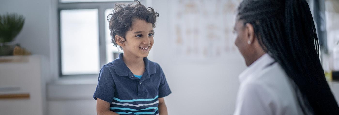 A young boy speaks with a doctor.