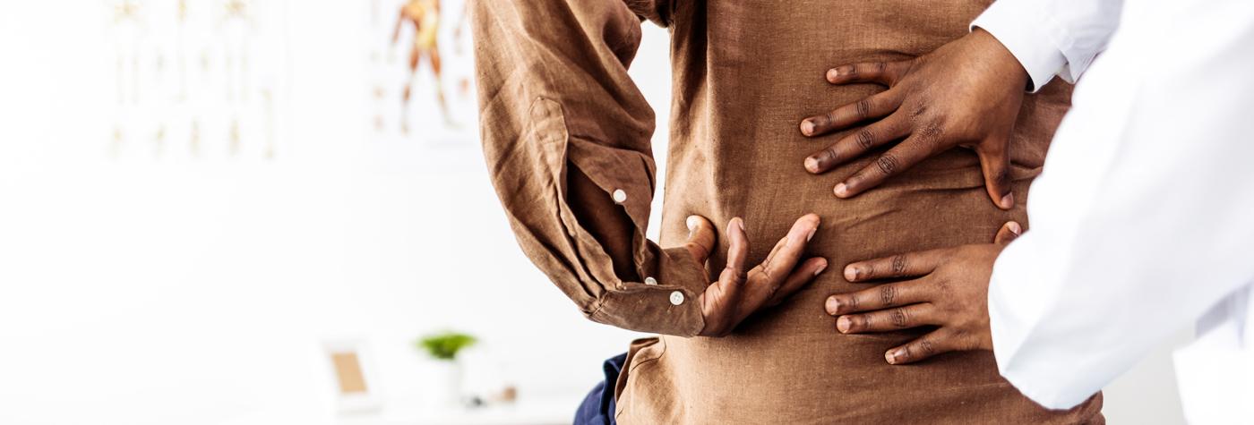 A doctor examines a patient's back