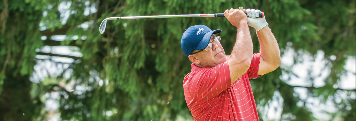 Doug Kuntz takes a swing with his golf club.