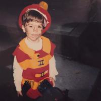 Nick Corman, as a young child, dressed in a fireman costume.