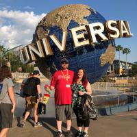 Garrett Dykes and his wife Kristin in front of the Universal Studios sign during their honeymoon