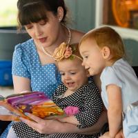 Sarah Custer reads to her daughters.