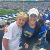 William Dean poses for a photo at a UK football game with one of his therapists