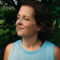Close up of Jeanne Hartman in an under armour shirt, breathing quietly with her eyes closed