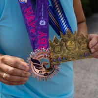Close up of several of Jeanne Hartman's medals from various marathons