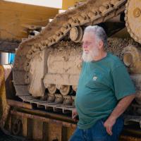 Shorty Carson leaning on his bulldozer