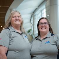 Two women, left Linda Baxter, pose for a portrait in the UK Albert B. Chandler Hospital lobby