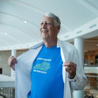 Tom Williams poses for a photo where he reveals a T-shirt that says Second Chance One Kentucky under a white collared shirt