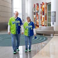 Tom Coleman, left, and Debbie Coleman walk through the lobby of UK Albert B. Chandler Hospital wearing Donate Life jerseys