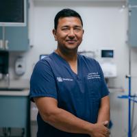 Dr. Ashish Maskey poses for a portrait in a procedure room