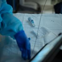 Medical equipment being prepared during a BLVR proceudre. A provider manipulates a screen, out of focus slightly