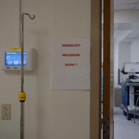 Sign indicates Endoscopy Procedure Room 7, which is being prepared. Ashish Maskey is visible in image but out of focus.