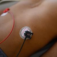 Two small electrodes are placed on AJ’s stomach during a check-up.