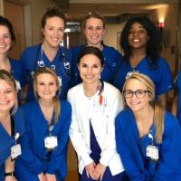 Allie smiles and poses alongside her fellow nurses at UK HealthCare’s Markey Cancer Center.