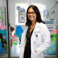 Dr. Shenoi smiles while working in the pediatric ICU at UK HealthCare.